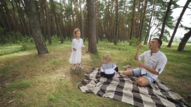 Happy active caucasian little girl playing with soap bubble in the park cute kid having fun in the autumn sunny park slow motion. High quality FullHD footage