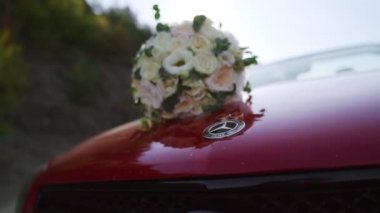 2.08.2022 Kiev, Ukraine. Wedding day. Bouqet on a red Mercedes cabrio. FullHD