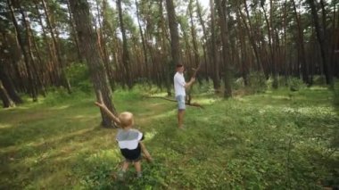 Father and son are cleaning in the forest. . High quality FullHD footage