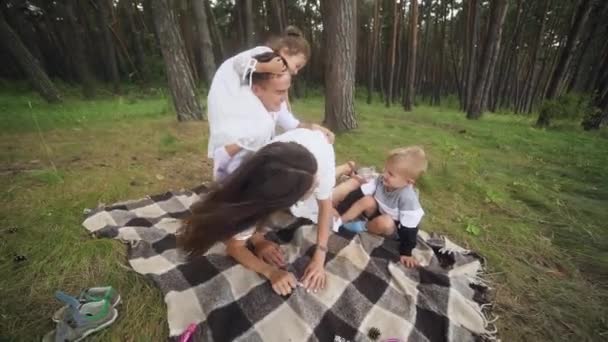 Laughing Parents Tickling Cute Kids Picnic Blanket Wide Shot Parents — Stockvideo