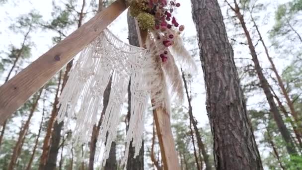Γκρο Πλαν Γαμήλια Αψίδα Διακοσμημένη Παστέλ Ξεθωριασμένα Λουλούδια Στο Δάσος — Αρχείο Βίντεο