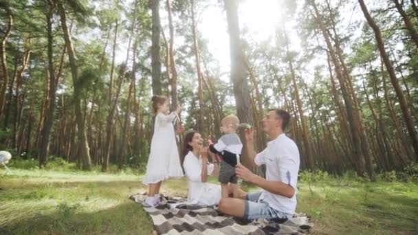 Happy Family Including Mother Father Two Kids Blowing Soap Bubbles — Wideo stockowe