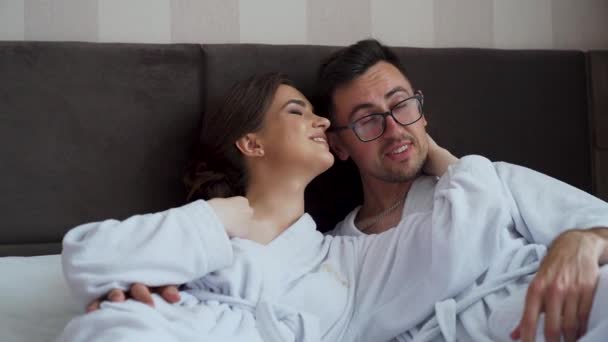 Young Couple Bathrobe Enjoying Together Time Wellness Hotel Room Lying — Video Stock