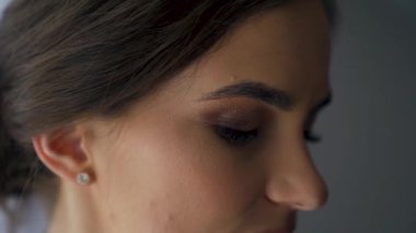 Extreme close up of Woman opening beautiful eyes. Attractive girl, a young female model with natural make-up and long eyelashes looking at camera. Slow-motion. High quality FullHD footage