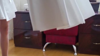 Close up. the bride takes off her wedding dress and posing near mirrow. Rotating the dress. Slow motion. High quality FullHD footage