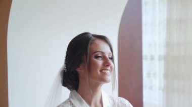 the bride takes off her wedding dress and posing near mirrow. Rotating the dress. Slow motion. High quality FullHD footage
