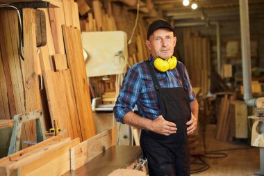 Üniformalı marangozun portresi marangozluk fabrikasında marangozluk yapıyor.