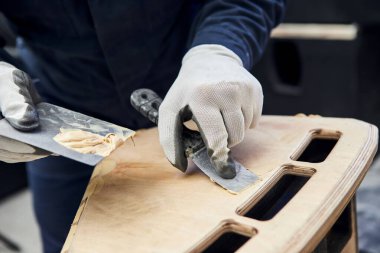 Tahta parçası. Marangozluk fabrikasında ahşap ürünleri yağmalayan el işçisi. Çalışma sürecini kapat