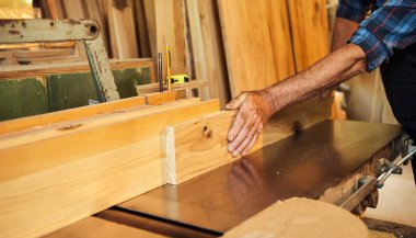 Üniformalı kıdemli marangoz marangozluk fabrikasında marangoz olarak çalışıyor.