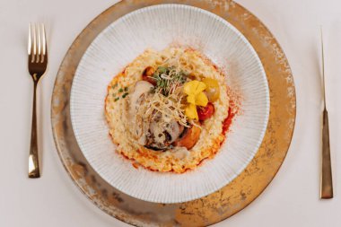 Restoranda sebze ve pirinç yastığında kuru erikli rulo et servis edilir.