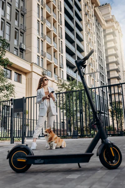 Beautiful Young Woman Sunglasses White Suit Standing Her Electric Scooter — Fotografia de Stock