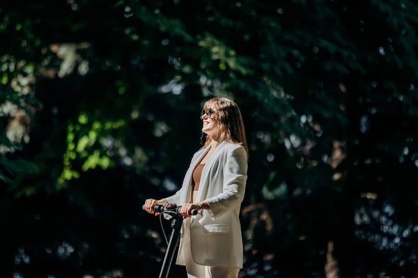 Beautiful Young Woman Sunglasses White Suit Standing Her Electric Scooter — Fotografia de Stock