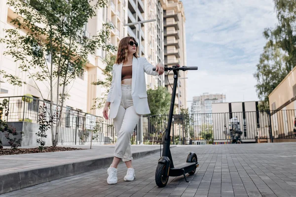 Beautiful Young Woman Sunglasses White Suit Standing Her Electric Scooter — 스톡 사진