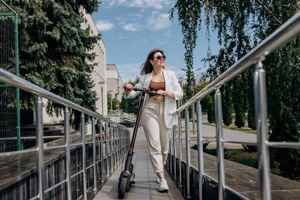 Beautiful Young Woman Sunglasses White Suit Walking Her Electric Scooter — Foto de Stock