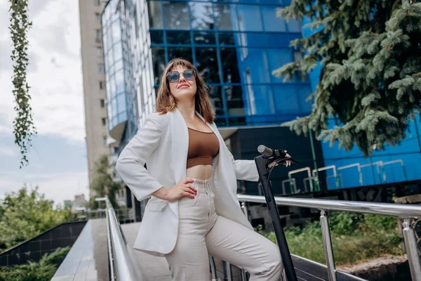 Beautiful Young Woman Sunglasses White Suit Standing Her Electric Scooter — Stockfoto