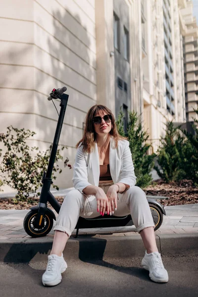 Young Businesswoman White Suit Sitting Electric Scooter Walking City Looking — Foto de Stock
