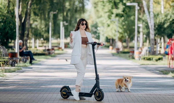 Beautiful Young Woman White Suit Sunglasses Standing Her Electric Scooter — Fotografia de Stock