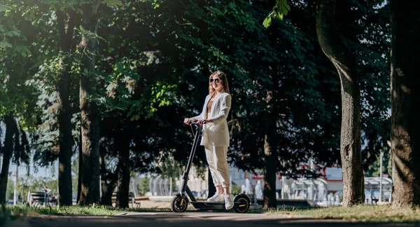 Beautiful Young Woman Sunglasses White Suit Standing Her Electric Scooter — Fotografia de Stock