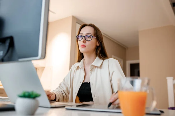 Woman designer working at home office on new ideas. Young happy female freelancer working on project, watching movie on computer, studying, blogging, resting and chatting online