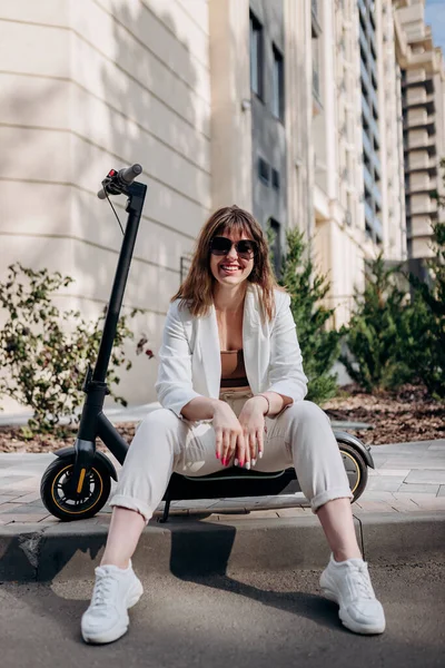 Young Businesswoman White Suit Sitting Electric Scooter Walking City Looking — Φωτογραφία Αρχείου