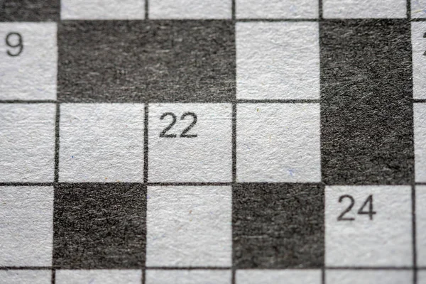 Crossword puzzle on grayscale newspaper Close up
