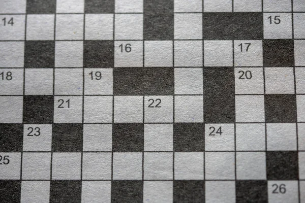 Crossword puzzle on grayscale newspaper Close up