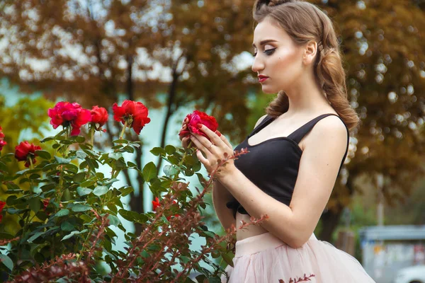 photo session of a pin-up girl in nature with roses