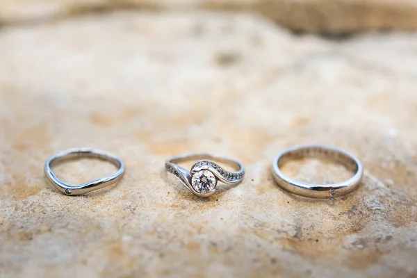Three wedding ring on a stone background — Stockfoto