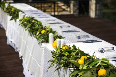 Limonlar, mumlar ve bardaklar düğün masasında..