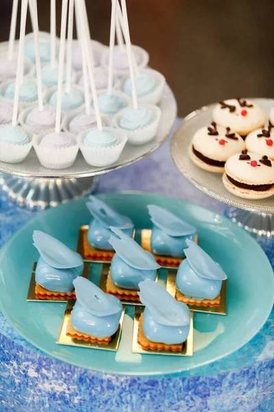 Rows of desserts on the birthday table. Ice concept