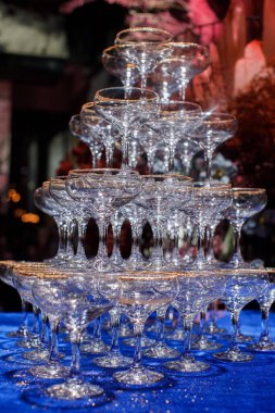 Pyramid of martini glasses on the table.