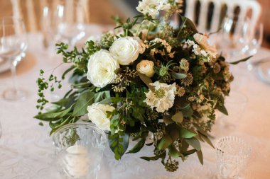 Düğün masasındaki vazoda bir buket çiçek..