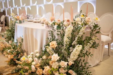 Düğün masasında vazodaki çiçek buketleri.