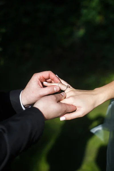 The groom wears a ring to the bride at the wedding ceremony