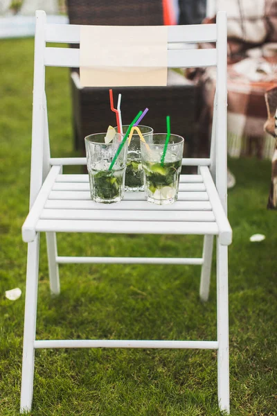 Drinks stand on a chair at a wedding party.