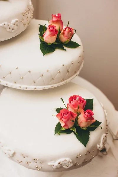 バラで飾られたテーブルの上に並ぶ結婚式のケーキ — ストック写真