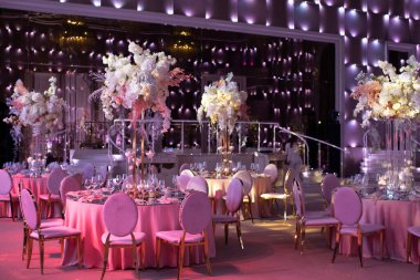 Decorated served tables for wedding party or other formal dinner.