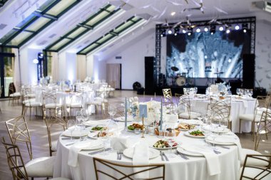 Decorated served tables for wedding party or other formal dinner.