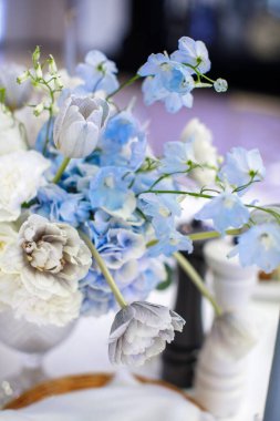 Bouquet of flowers in vase on the wedding table.