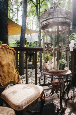 Vintage chair and cage at the wedding ceremony,