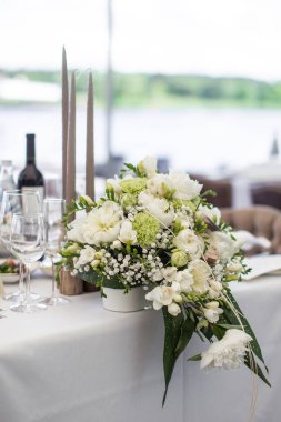 Düğün masasındaki vazoda bir buket çiçek..