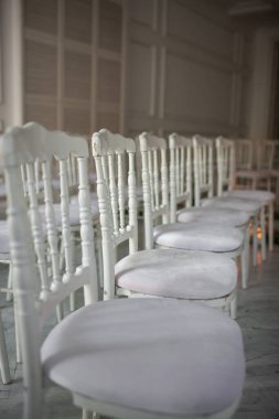 Wooden chairs for an outdoor wedding ceremony.