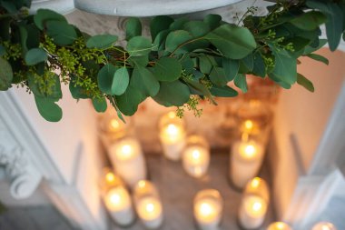 Green branch over the fireplace at the wedding.