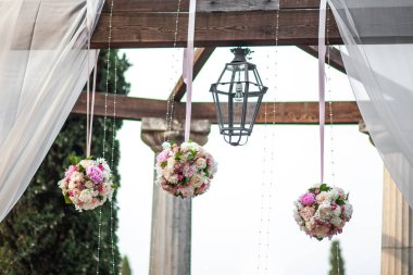 Beautiful and delicate flowers at the wedding ceremony. Hanging flower balls