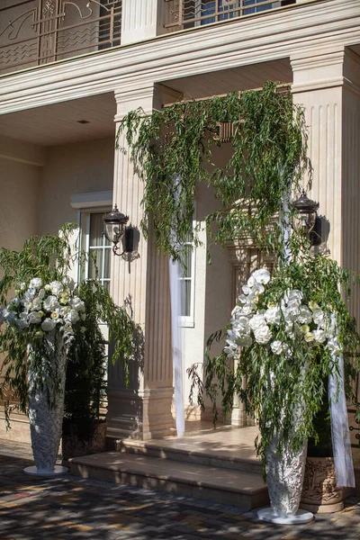 House entrance decorated with orchids for wedding.