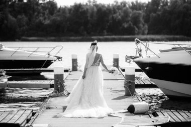Bride in wedding dress posing on the pier.