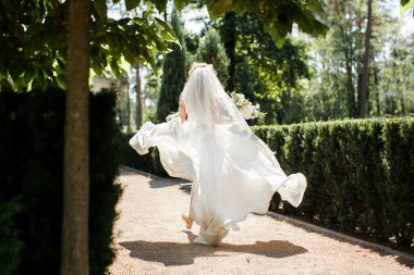 Bride in wedding dress posing in the garden.