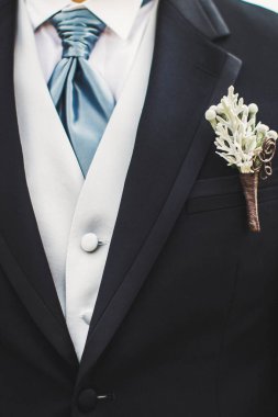 Elegant wedding boutonniere on the groom's suit.