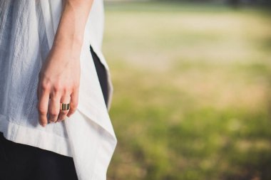 Engagement ring on bride's finger during wedding preparations.