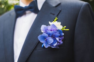 Elegant wedding boutonniere on the groom's suit.